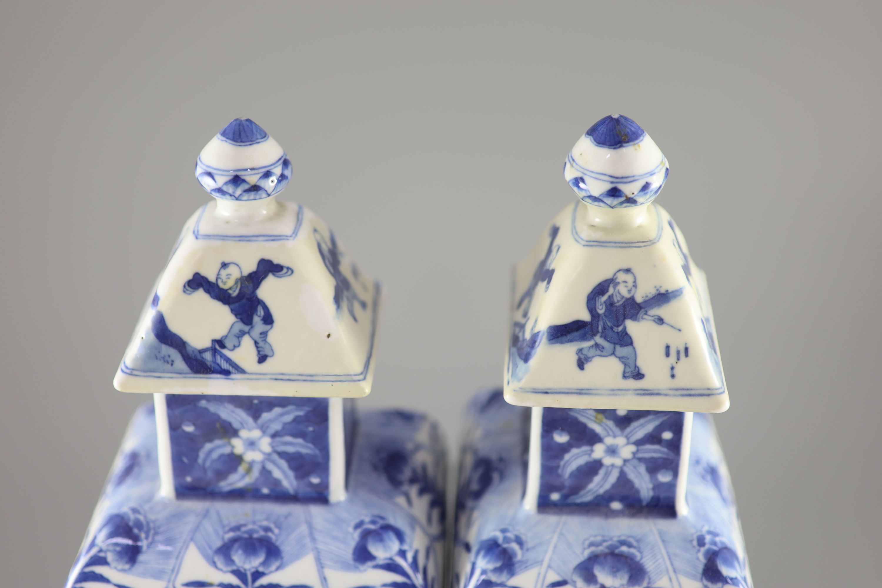 A pair of Chinese blue and white rectangular baluster vases and covers, Kangxi marks but 19th century, 36.5 cm